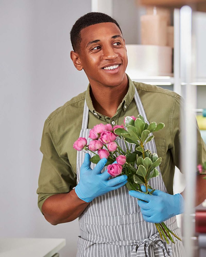cheerful-young-man-during-working-day-in-flower-sh-5K2QYR2.jpg